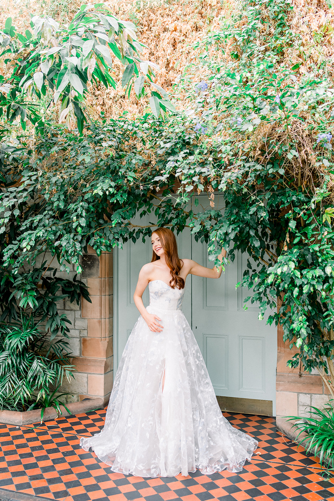 Bride in a Rami Al Ali gown touching the delicate fabric, epitomizing destination wedding luxury in Ireland's Castle Les