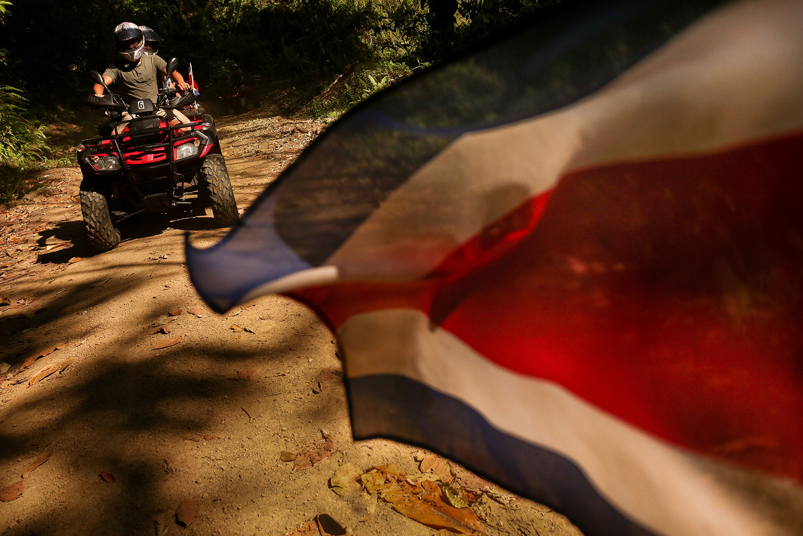Costa Rican flag and ATV tour in the mountains