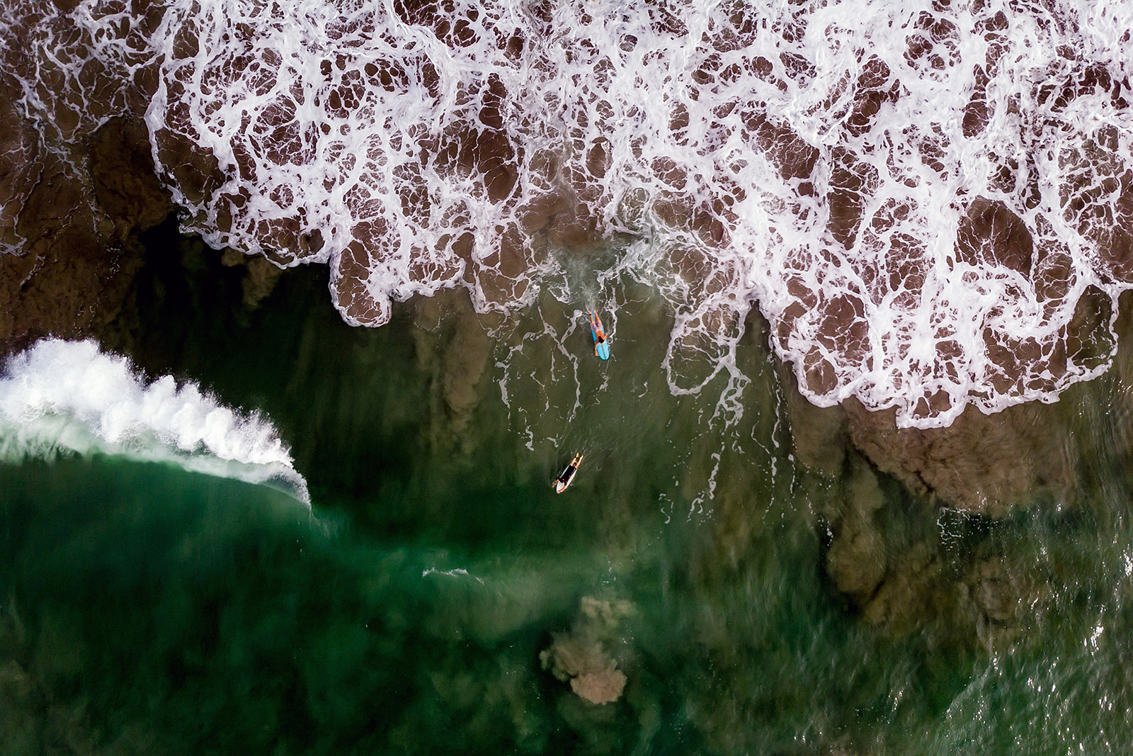 Surfers from above shot by drone
