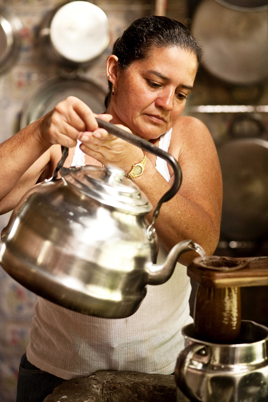 Woman making coffee the traditional Costa Rican way