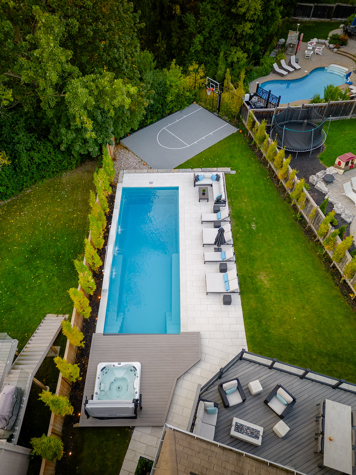 A drone-shot of the backyard and the inground pool.
