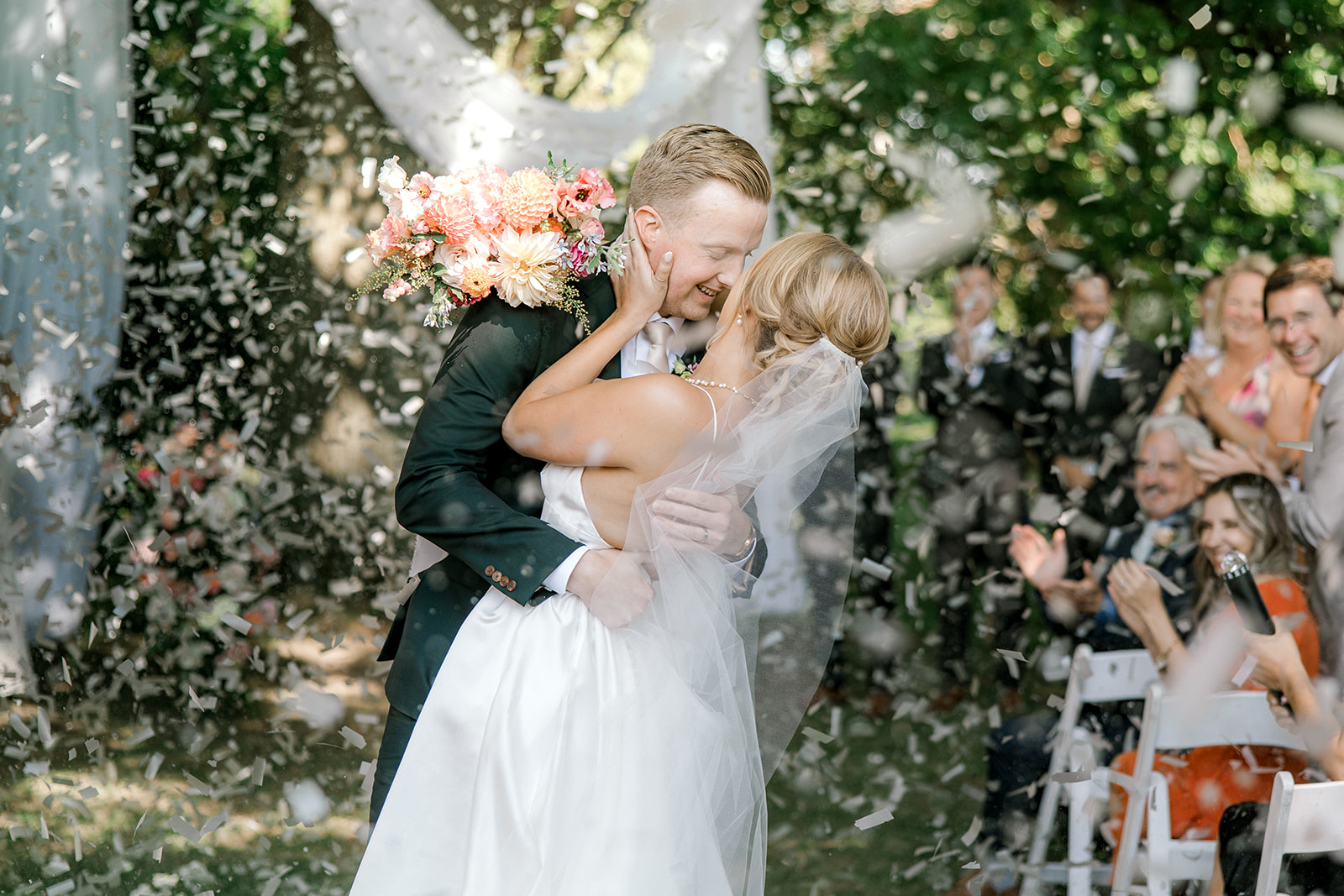 Couple kisses under confetti at their Kurtz Orchard Estate Wedding