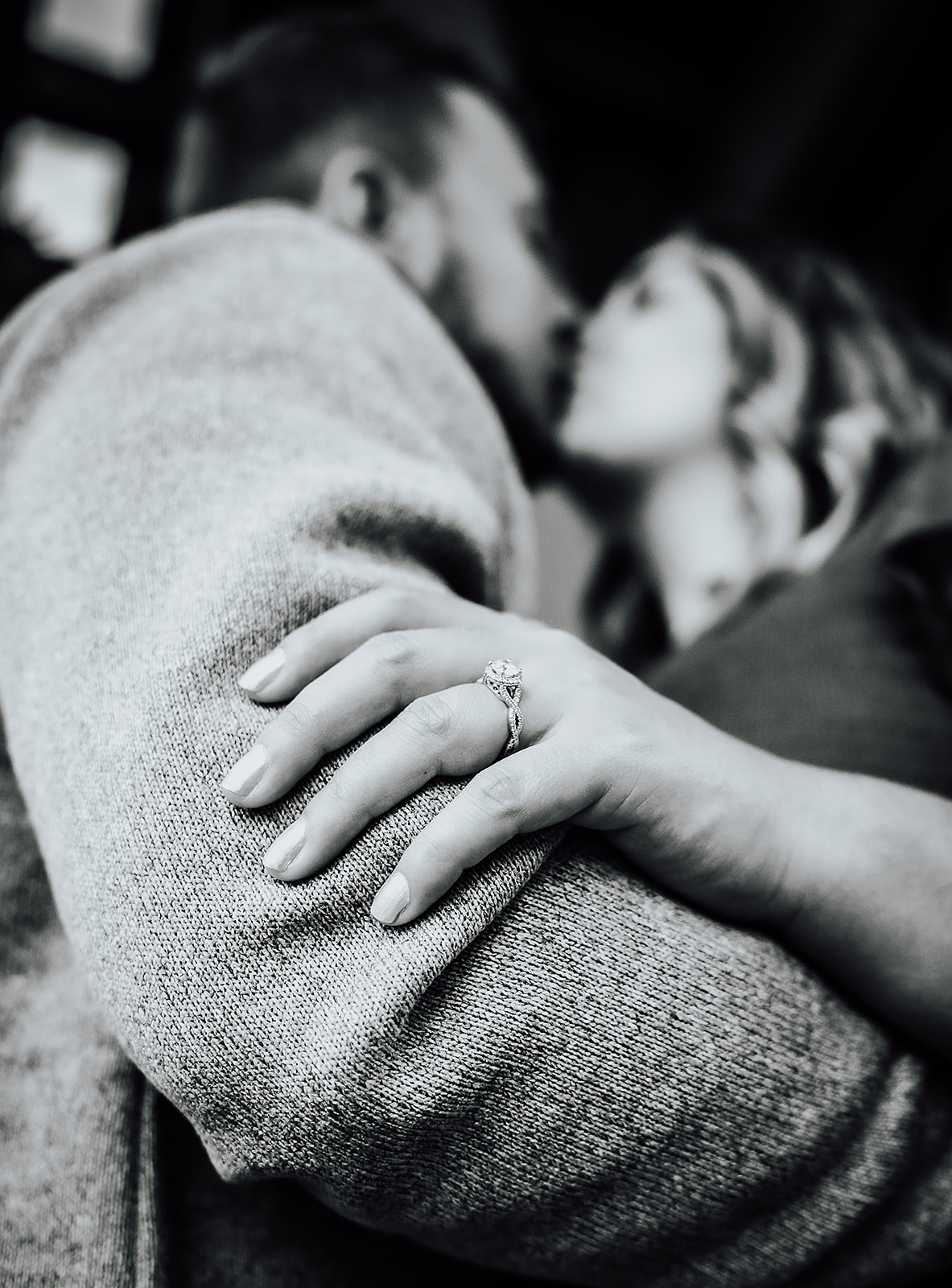 Black and white image of couple kissing featuring engagement ring Cox Arboretum Dayton Ohio