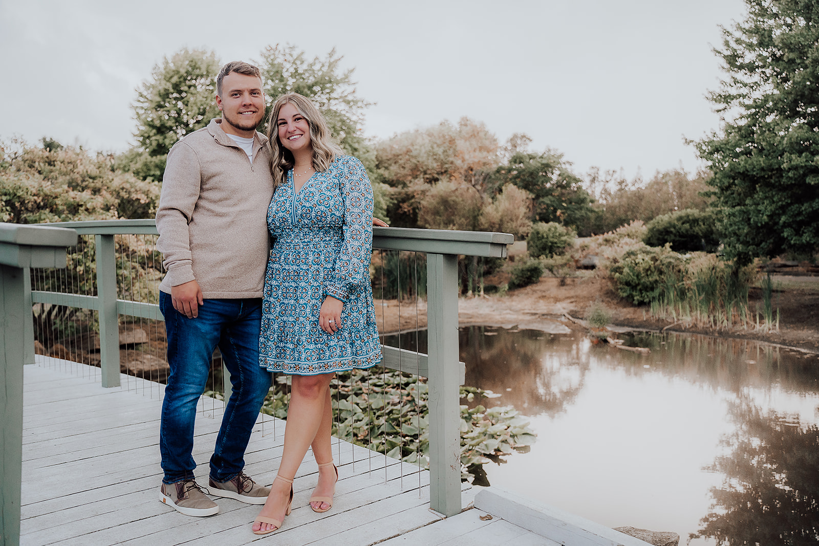 Engaged couple posing on bridge Cox Arboretum Dayton Ohio
