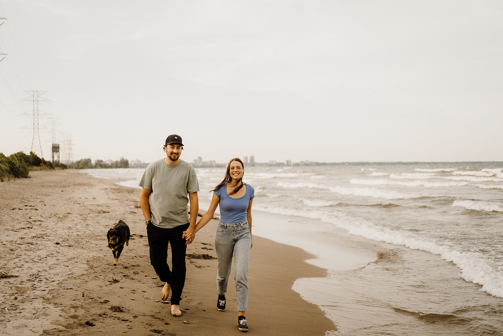 A man and woman walking on the beach together.