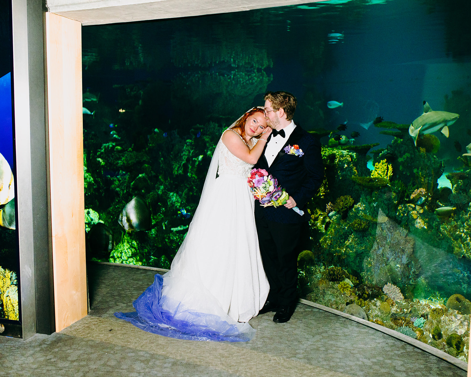 bride and groom taking photos at the national aquarium 