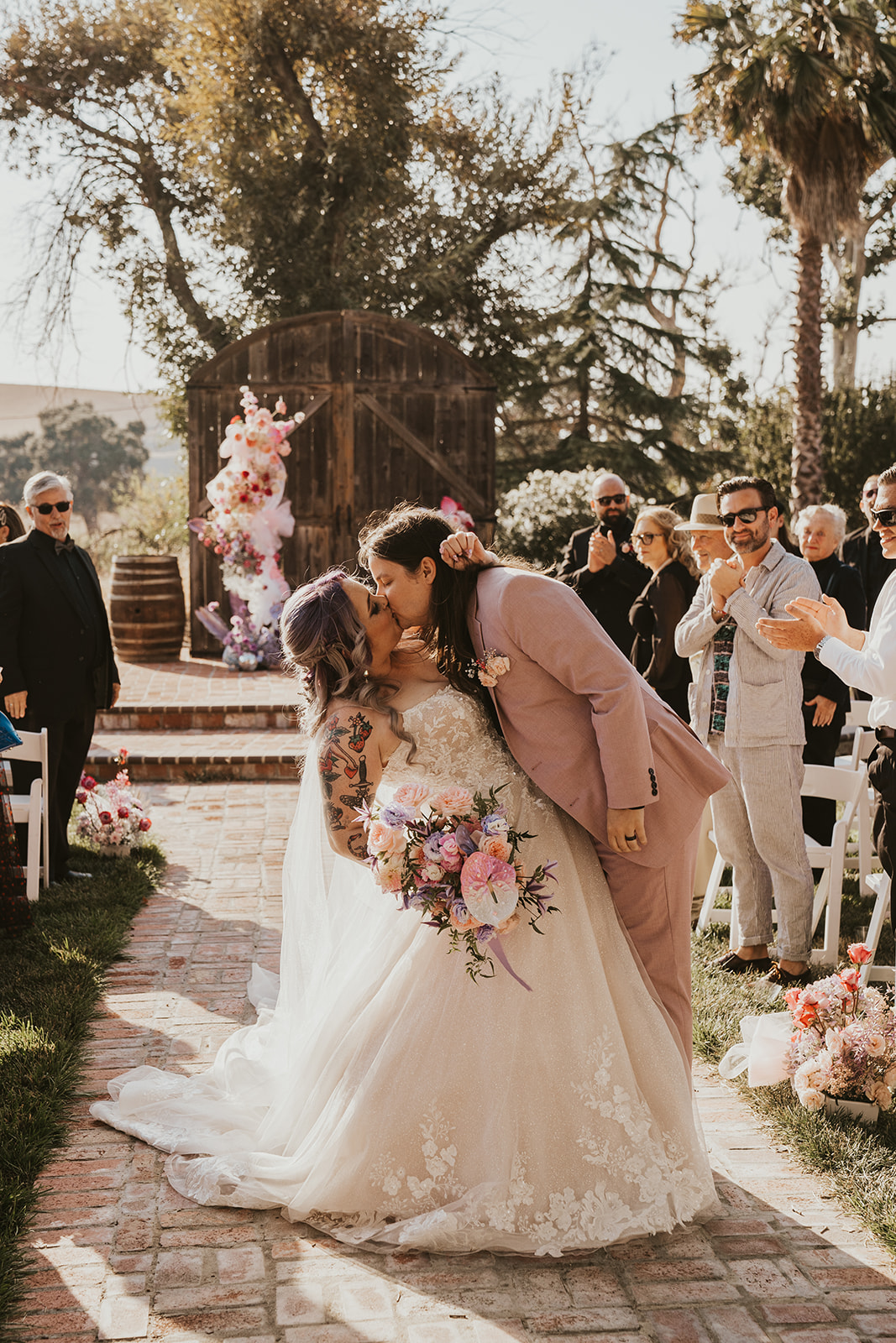Groom dips his bride into a kiss after wedding in Livermore, California wine country
