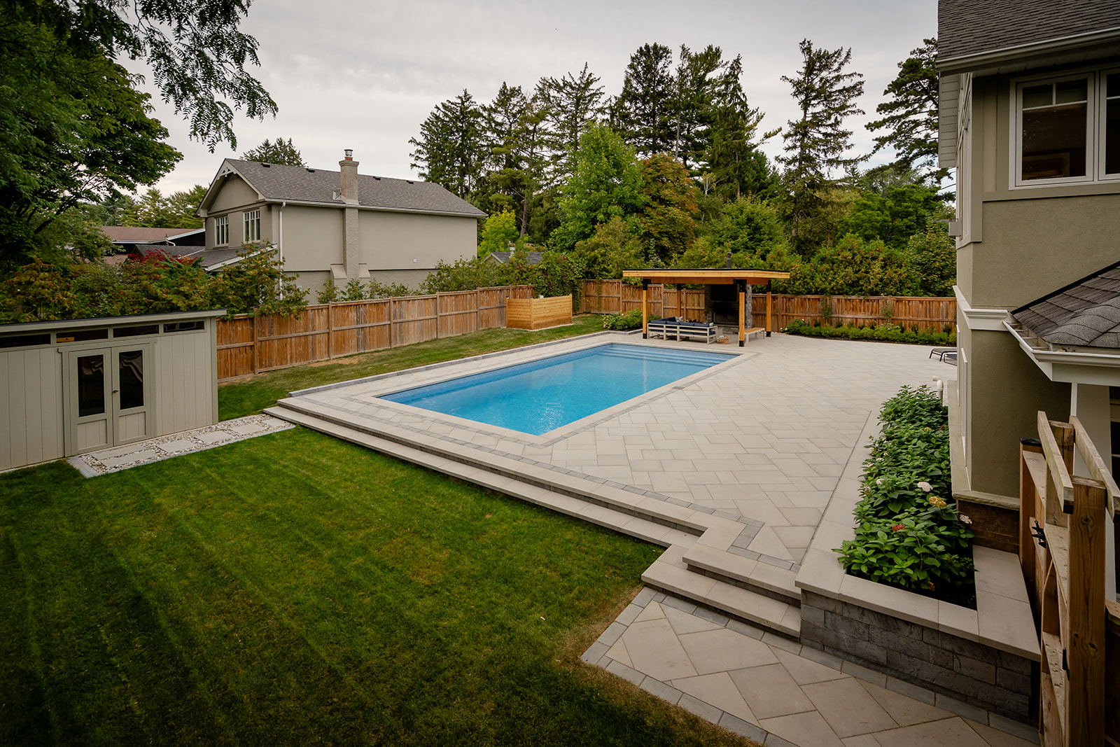A backyard with an inground pool.