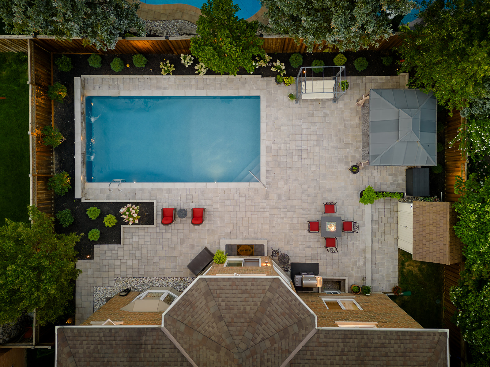A top-down view of an inground pool and furniture.