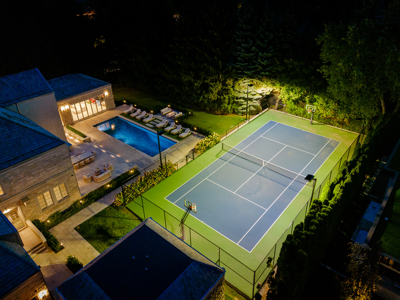 A done shot of the tennis court lit up at night.