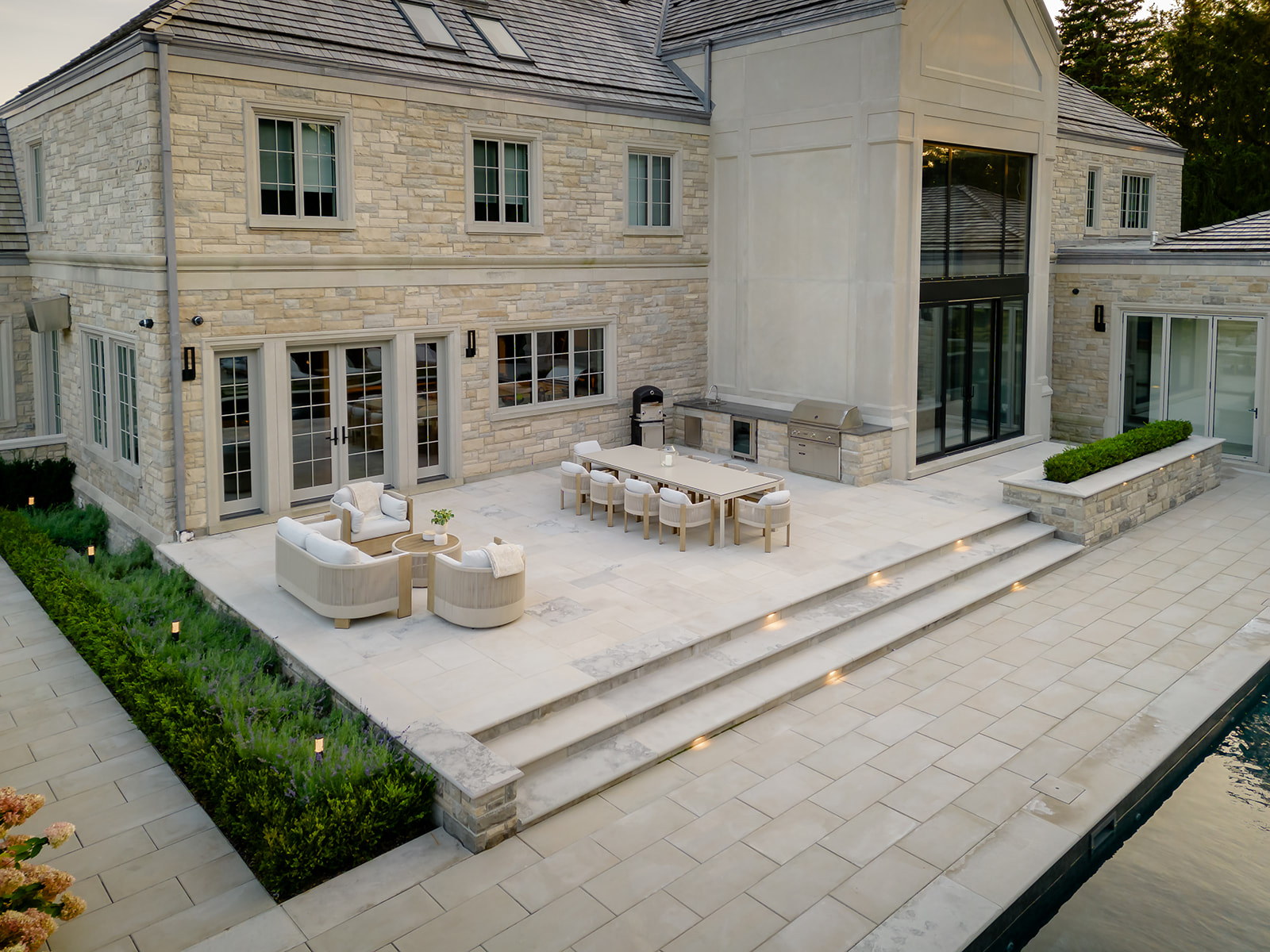 A patio with outdoor furniture on it connected to the house.