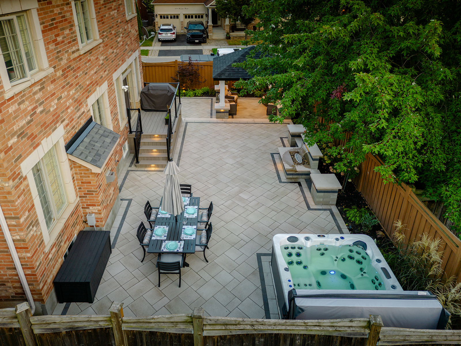Drone shot of the backyard with the jacuzzi and outdoor seating.