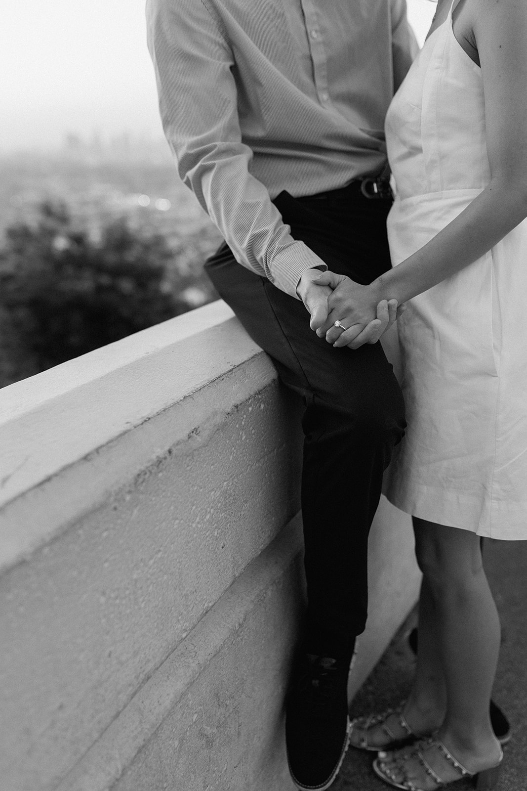 holding hand sunrise engagement session with engagement couple at los angeles' griffith observatory