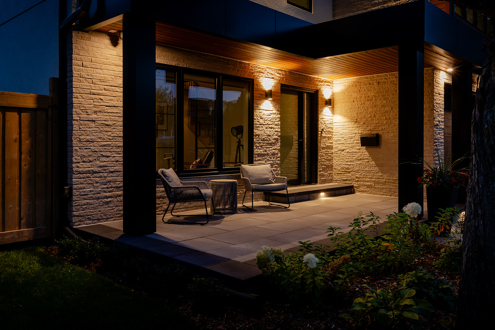 A porch lit up with outdoor furniture.