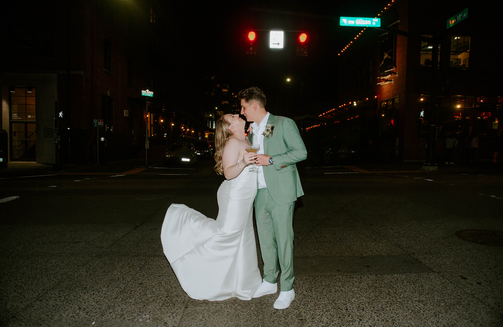 Bride and groom kissing at night in the road in the downtown Portland Pearl District