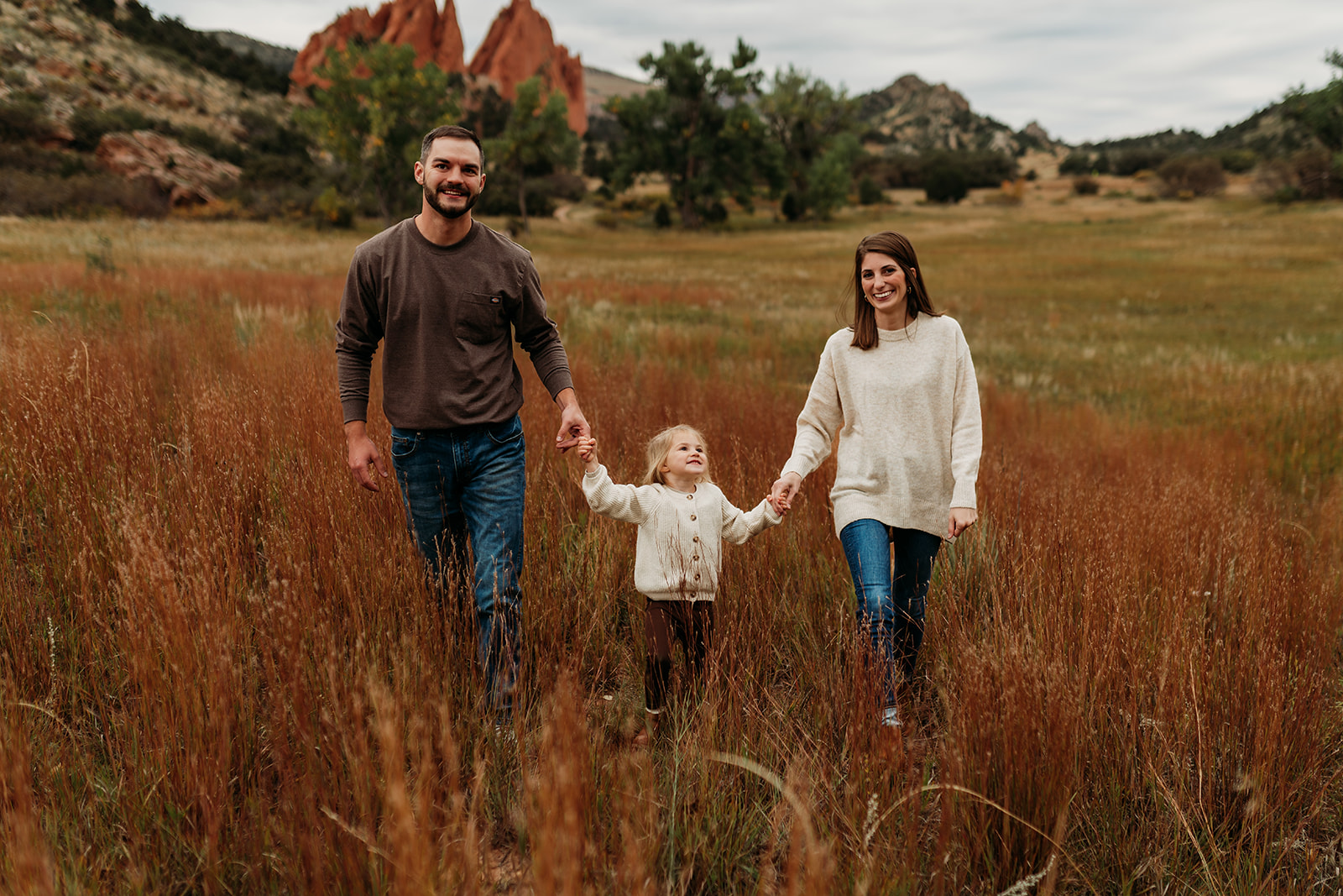 Small family standing in a field at Garden of the Gods Park in Colorado