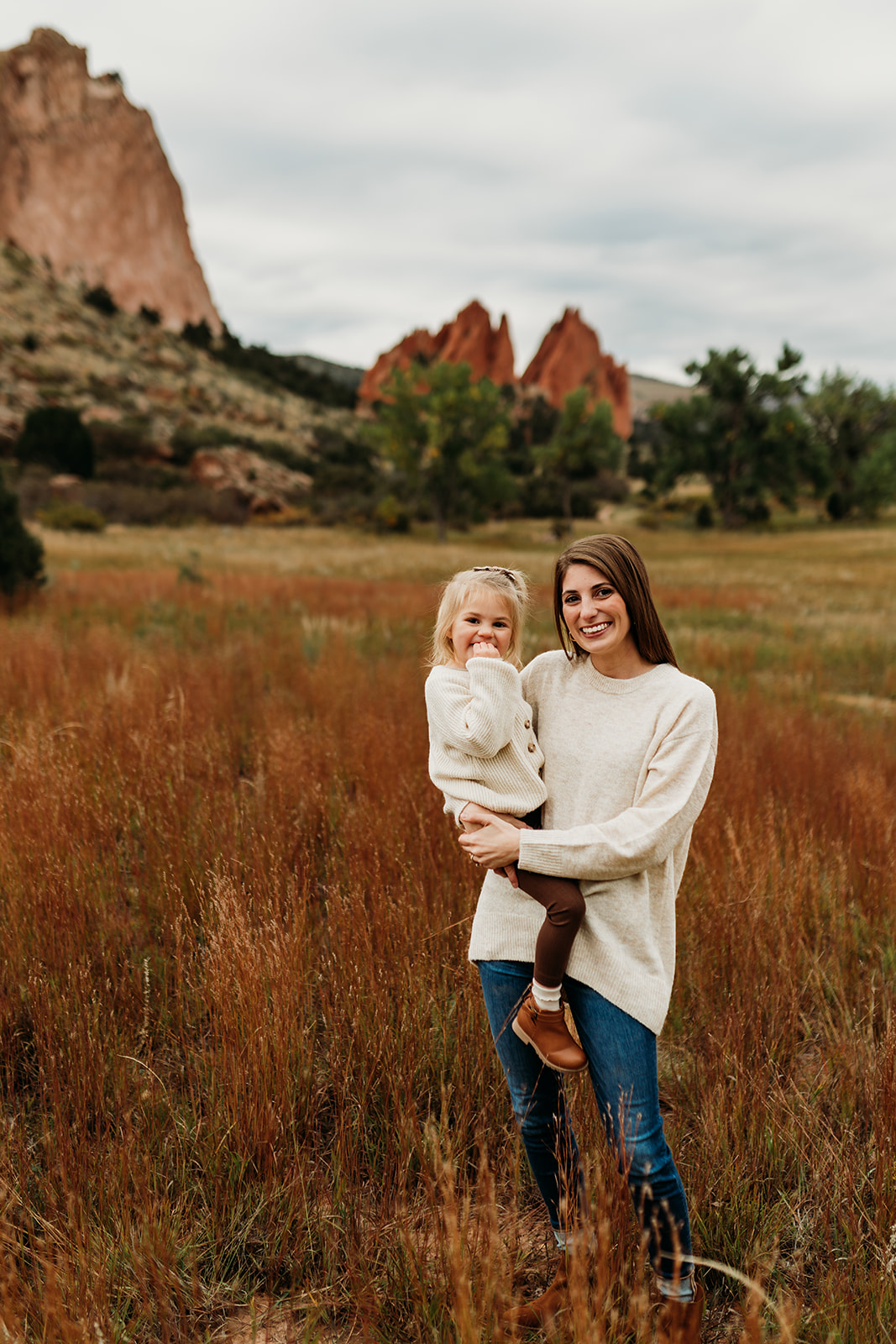Mom and daughter standing in front of giant boulders at Garden of the Gods Park in Colorado