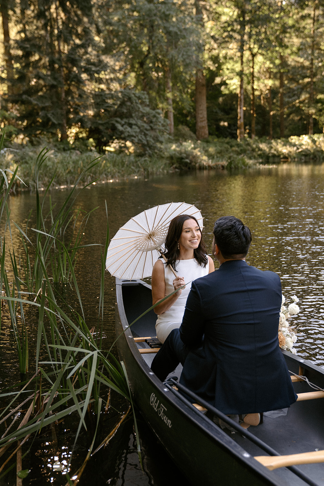 Modern white wedding at Bridal Veil Lakes with a canoe ride and sunny parasols