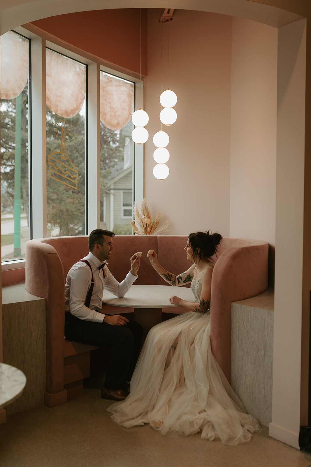 bride and groom enjoy treats at Sweet Imperfections Bakery in Winnipeg