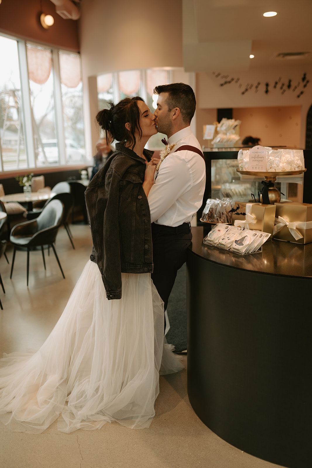 bride and groom enjoy treats at Sweet Imperfections Bakery in Winnipeg