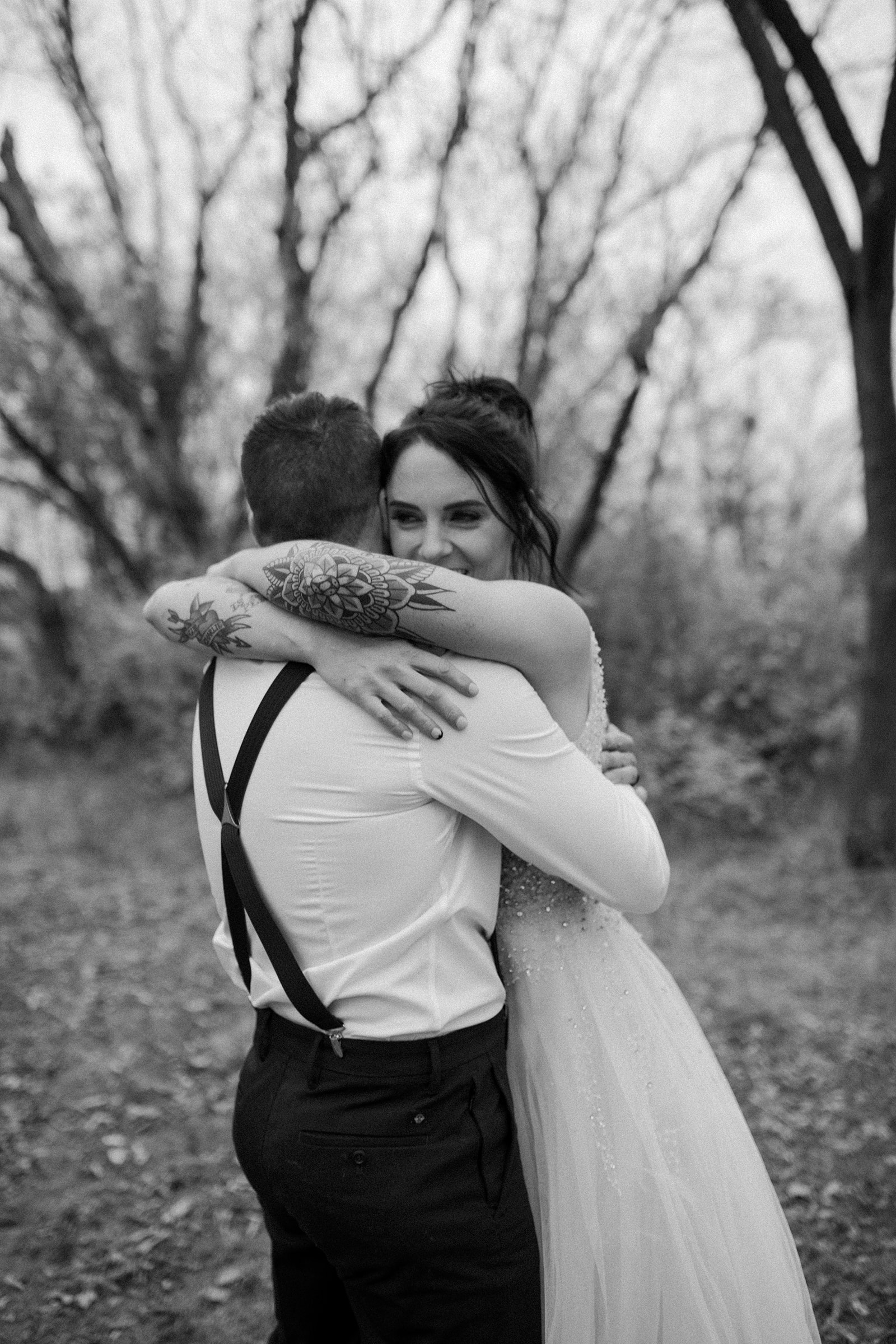 bride and groom hugging in the forest after their ceremony