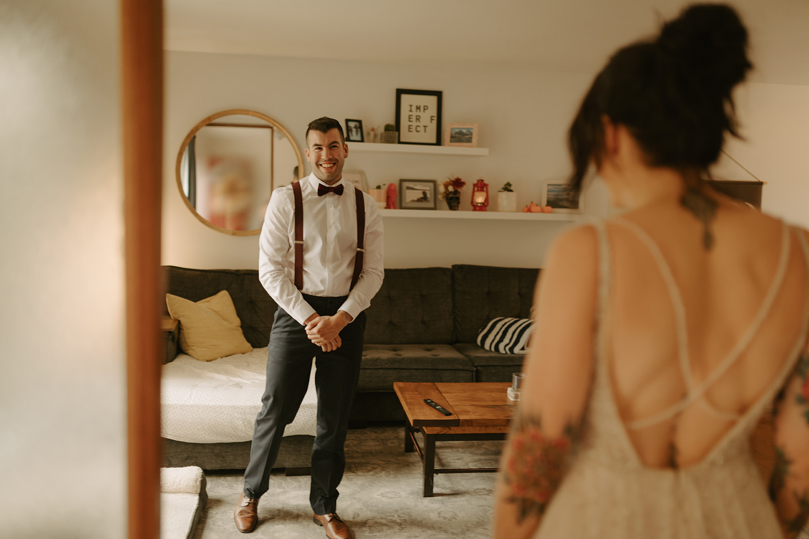 first look with bride and groom in their living room 