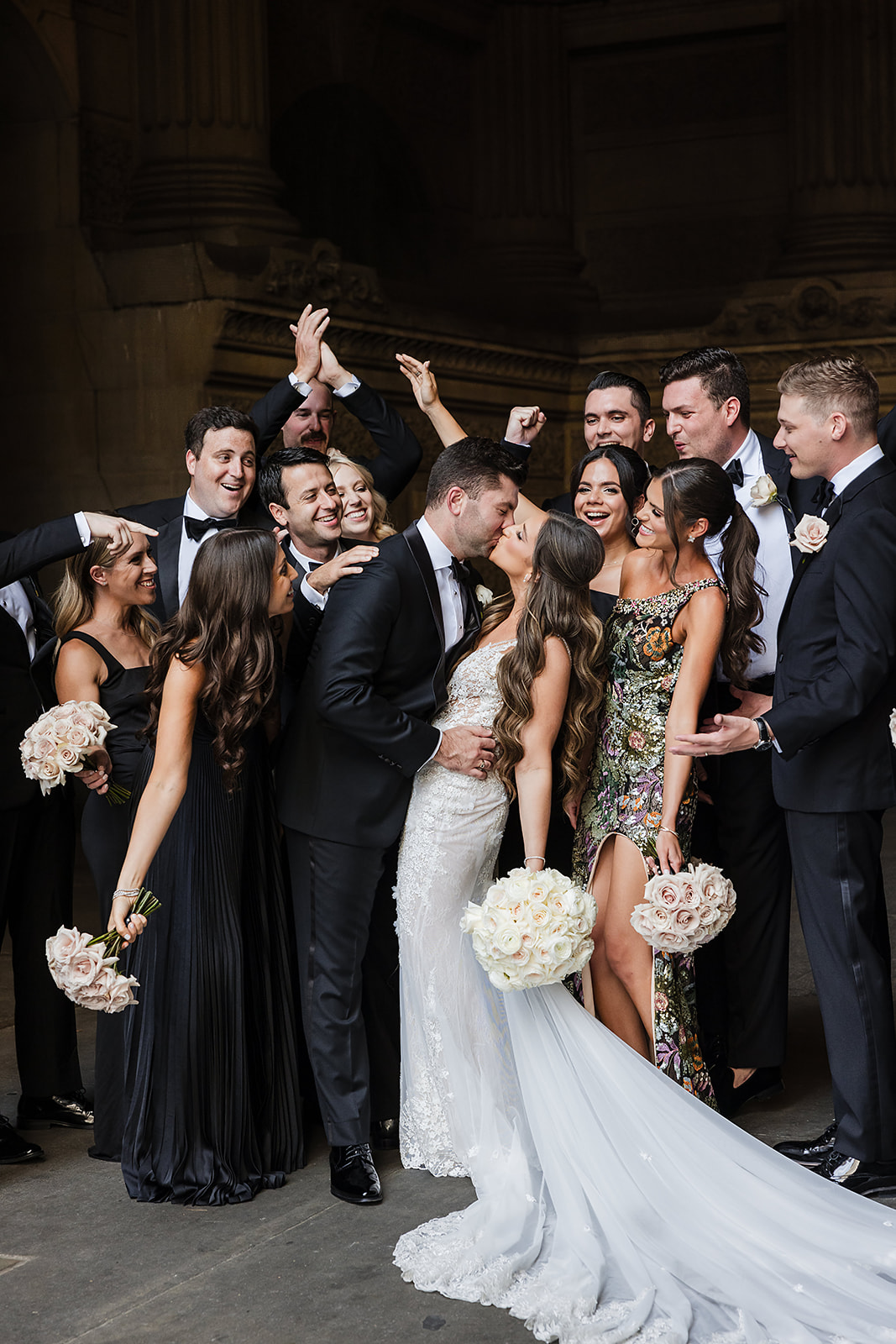 Chic and elegant Bridal party with black maxi dresses and timeless ivory rose bouquets at The Crystal tea Room wedding 