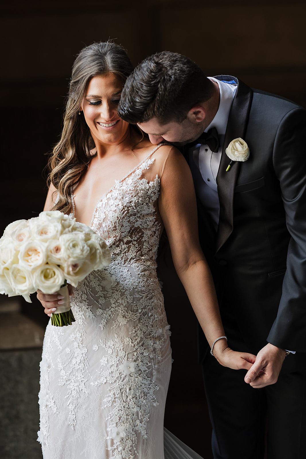 Groom kissing the bride shoulder at Crystal Tea Room Jewish luxury wedding in Philadelphia