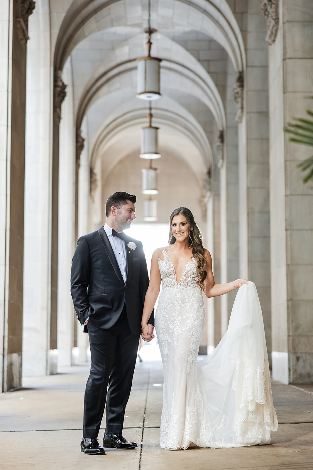 Stunning wedding portrait of the bride and groom at the Notary Hotel archway in center city Philadelphia