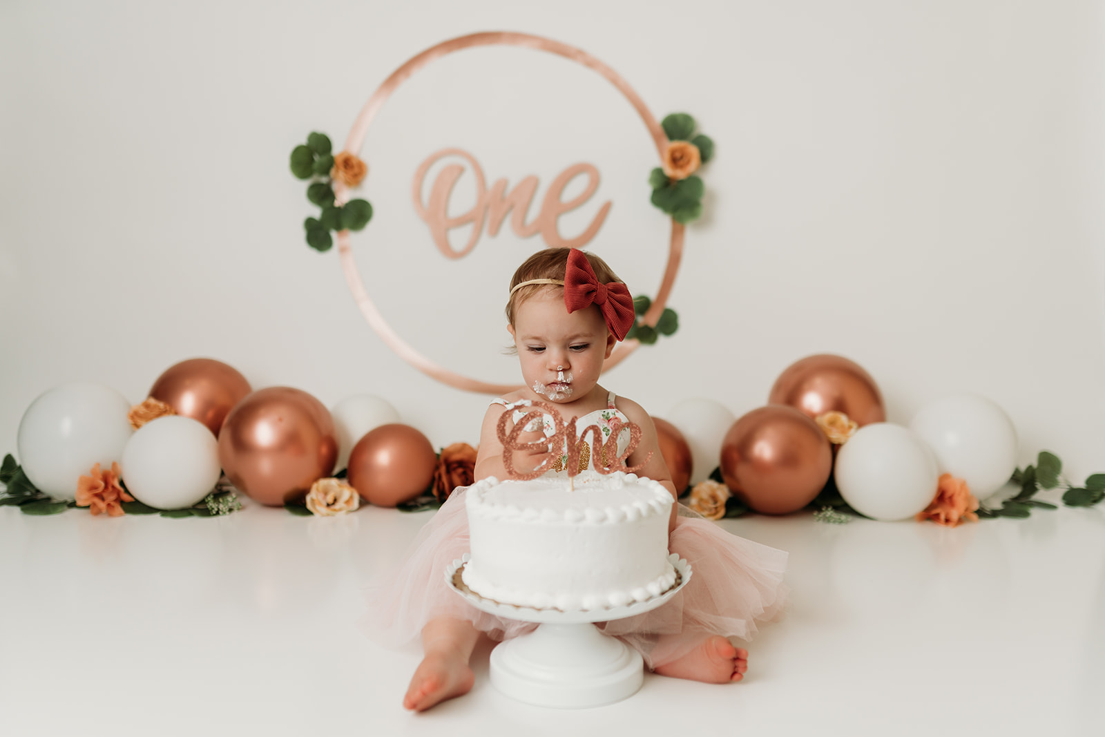 1 year old smashes into cake during cake smash photo shoot with Heather Ann Photography in Colorado Springs 