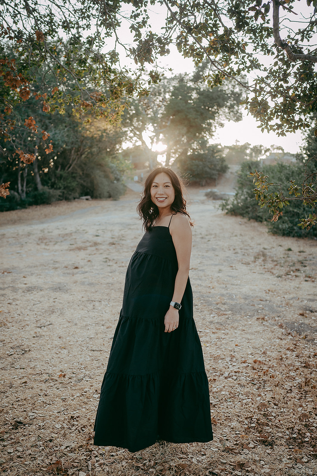 Pregnant woman wearing black dress for maternity photos