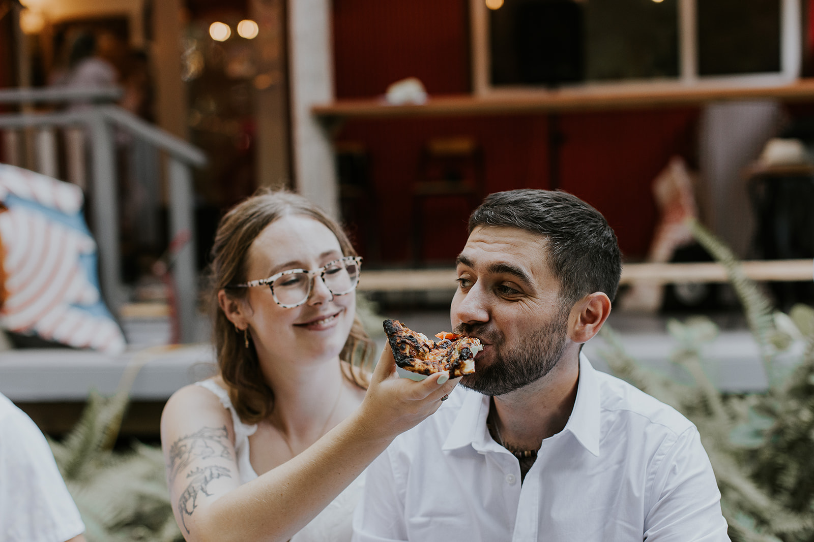 bride and groom eating pizza at wedding 