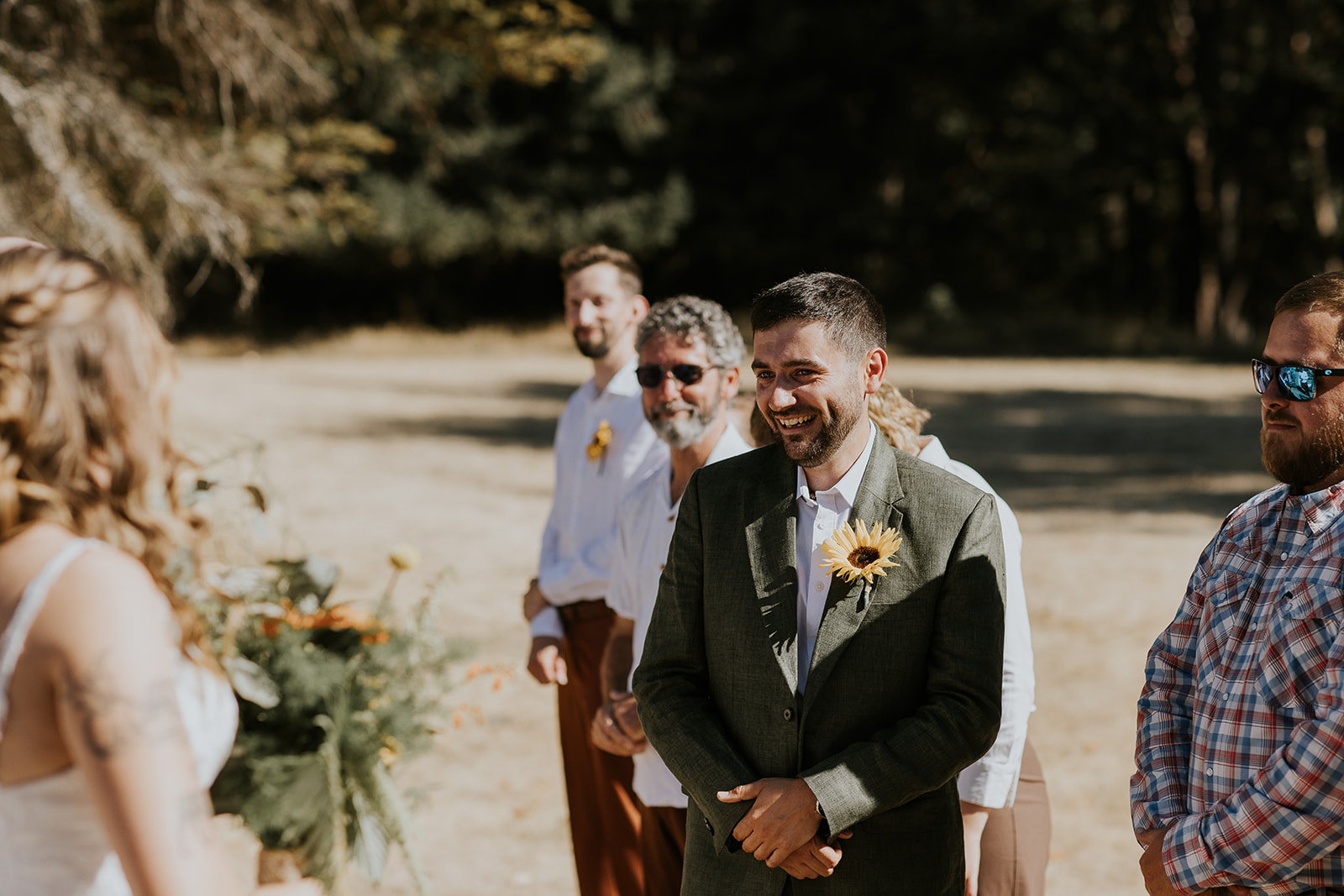 groom getting emotional while watching bride come down aisle 