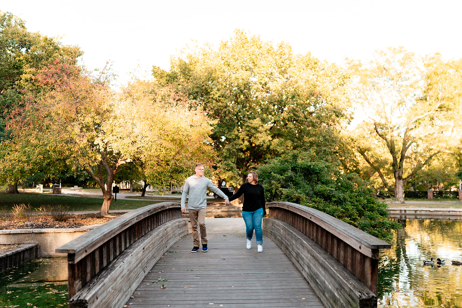couple walking at loose park for engagement photos