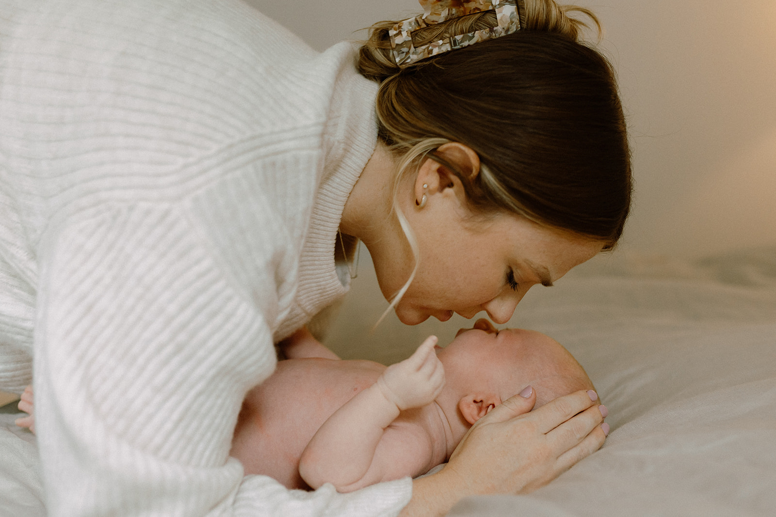 kelowna newborn family photographer kisses from mom documentary style
