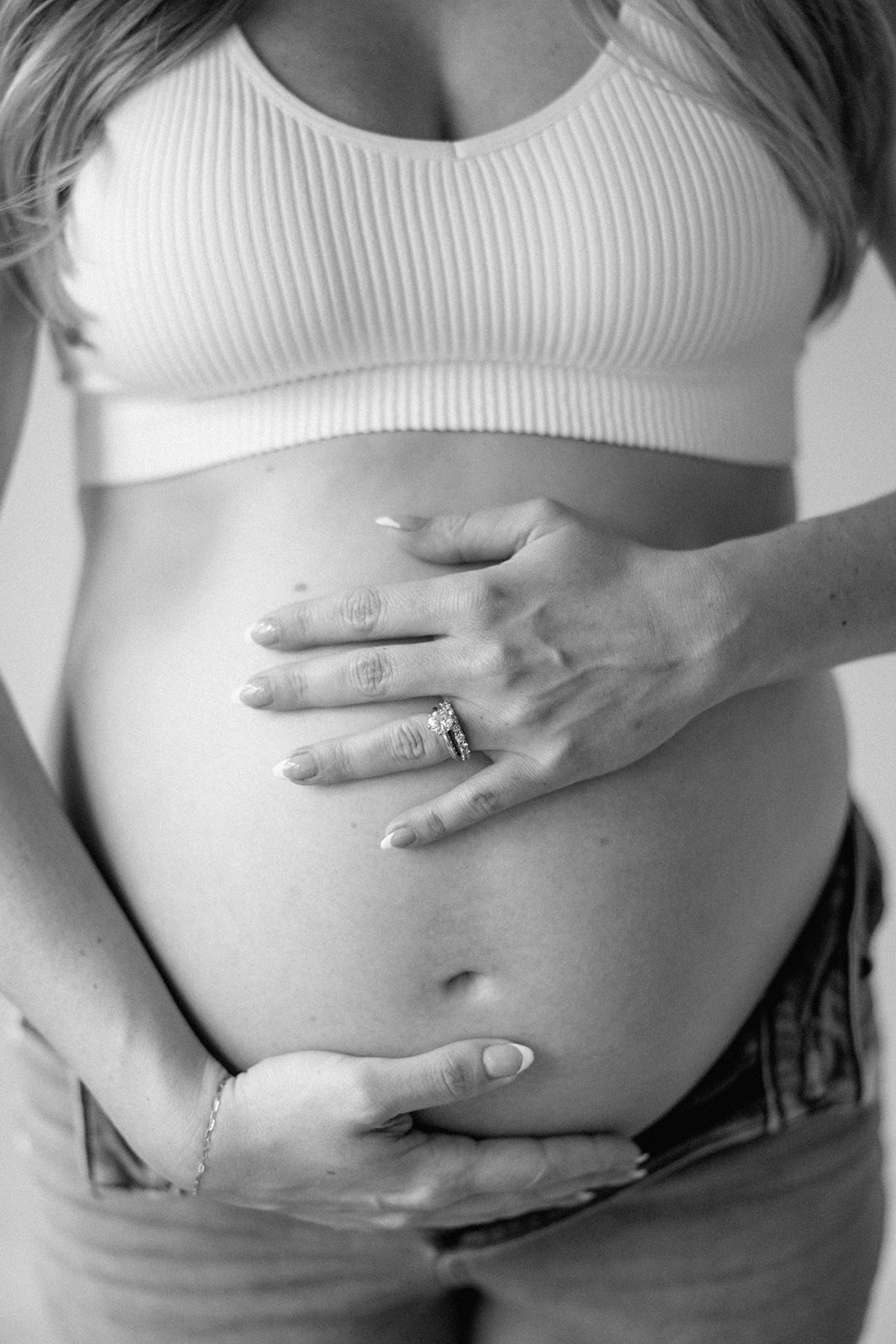 Black and White photo of expectant mother holding her baby belly