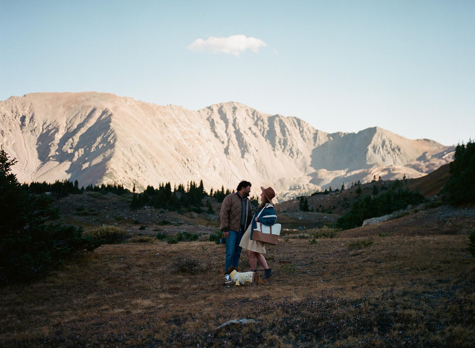 A film phot of the glorious mountains, fully lit by the setting sun, and the couple posing before moving locations.