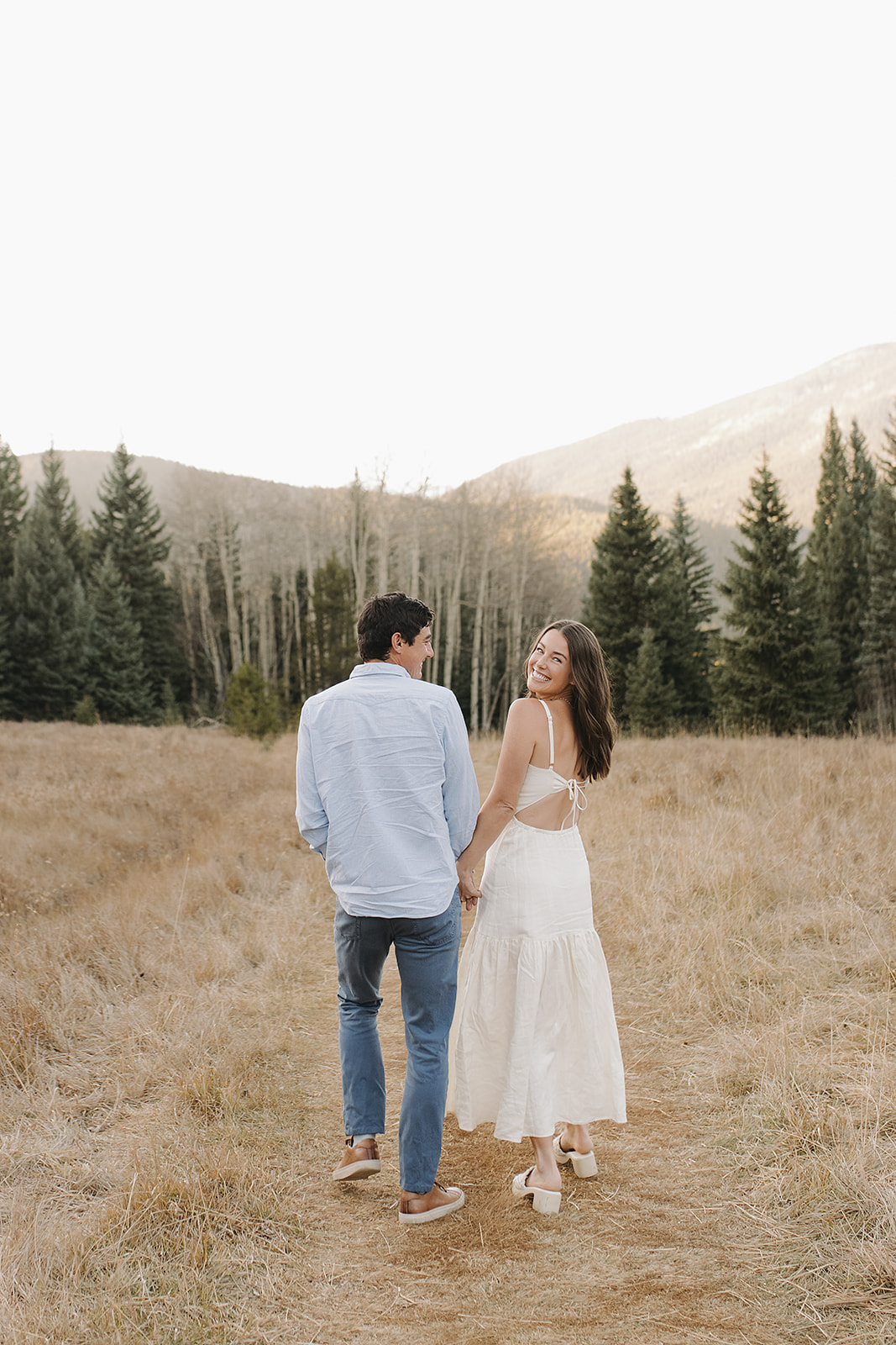 Engagement session portraits with Colorado mountain backdrop in Evergreen