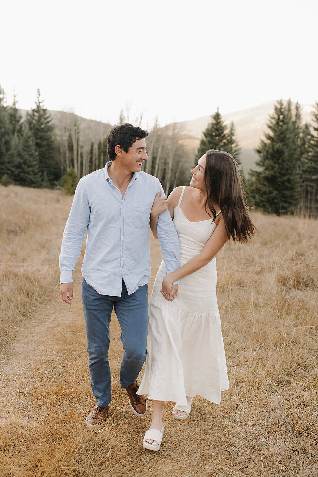 Happy couple George and Alisa take destination engagement photos in Colorado's rocky mountains