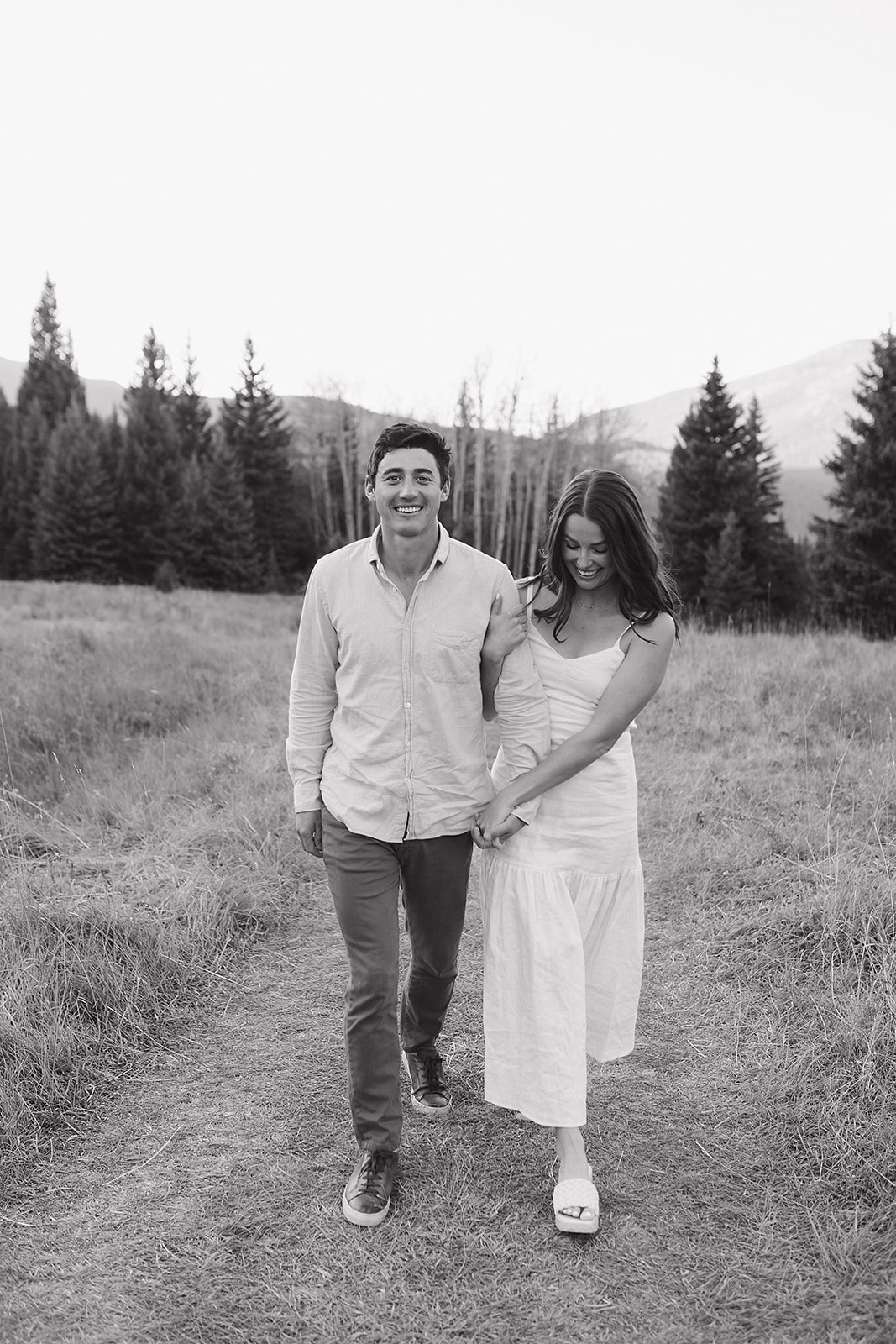 In-love newly engaged couple getting their engagement photos done in Evergreen, Colorado