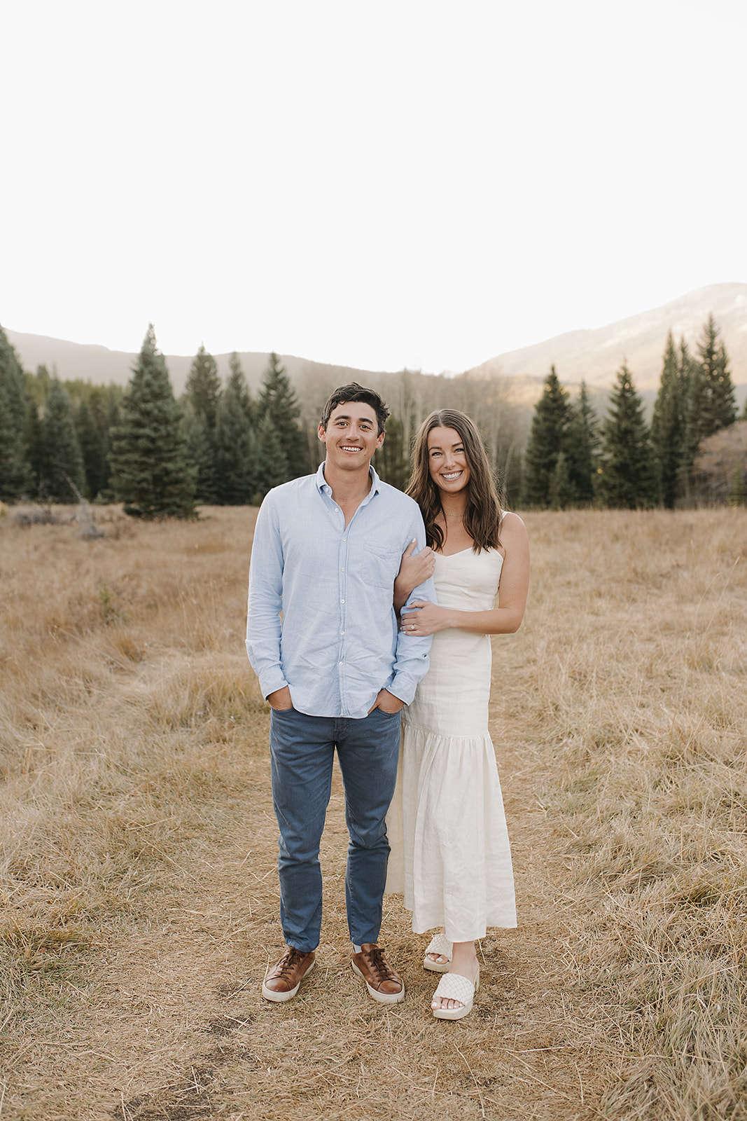smiling and posed engagement photography in Evergreen, Colorado