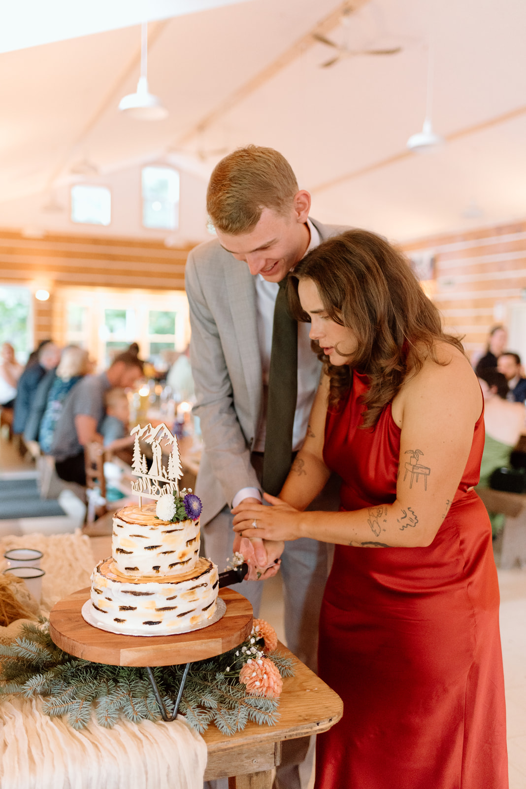 a bride and groom cutting their wedding cake during their reception at Lake Couchiching. 