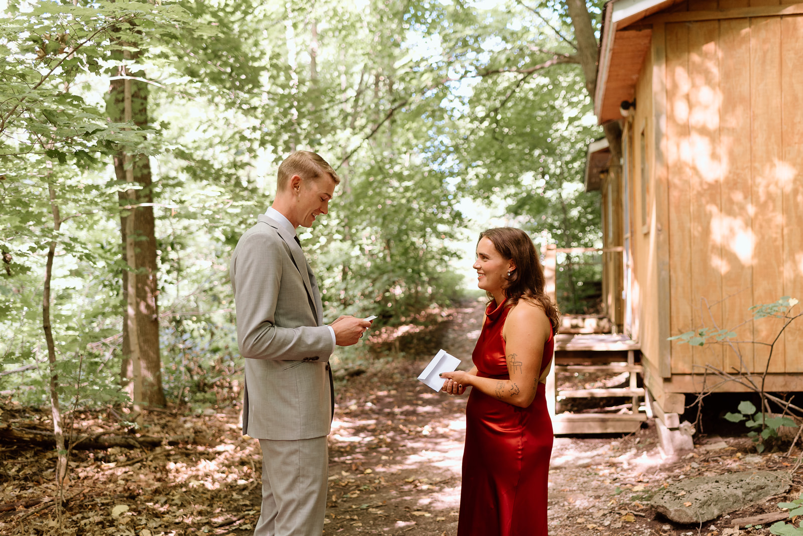 a bride and groom say the vows in the woods at camp couchiching 