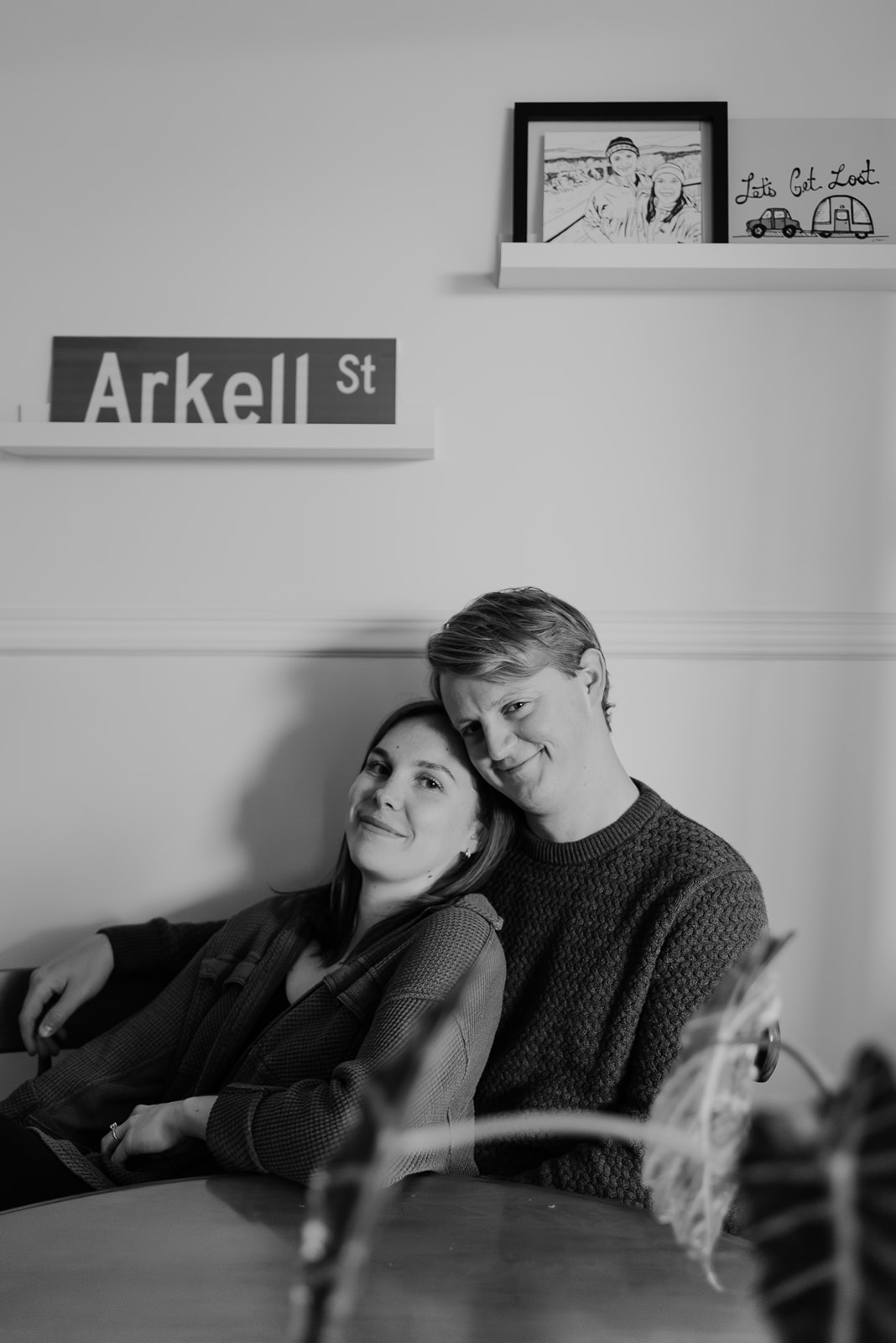 An engaged couple in their home during an engagement session. 