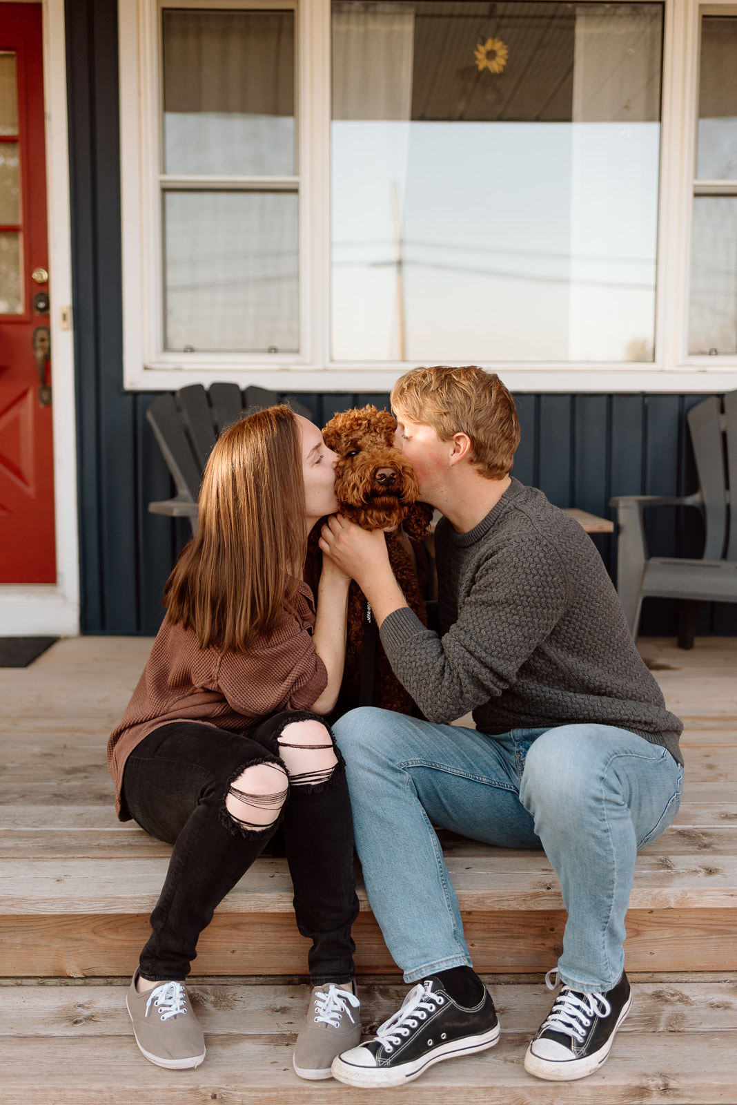An engaged couple and their dog outside their home near Barrie, Ontario. 
