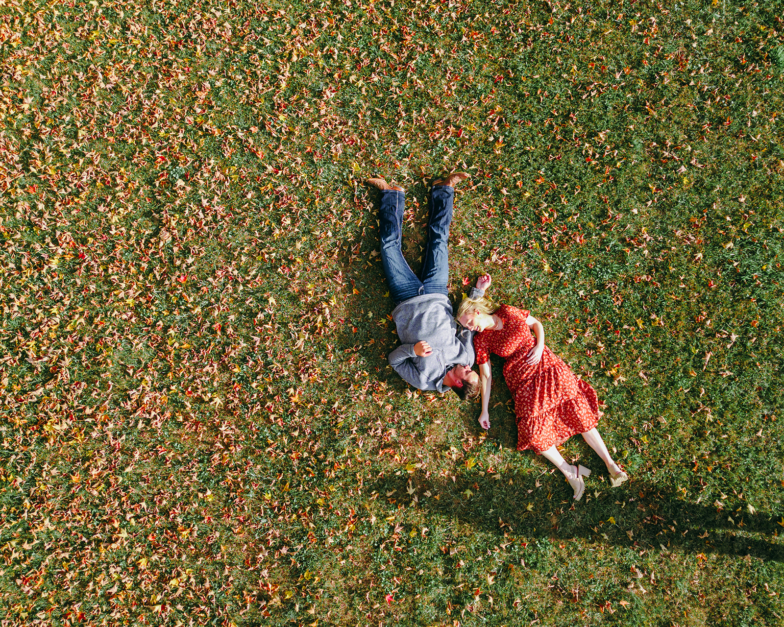 couple laying together in leaves