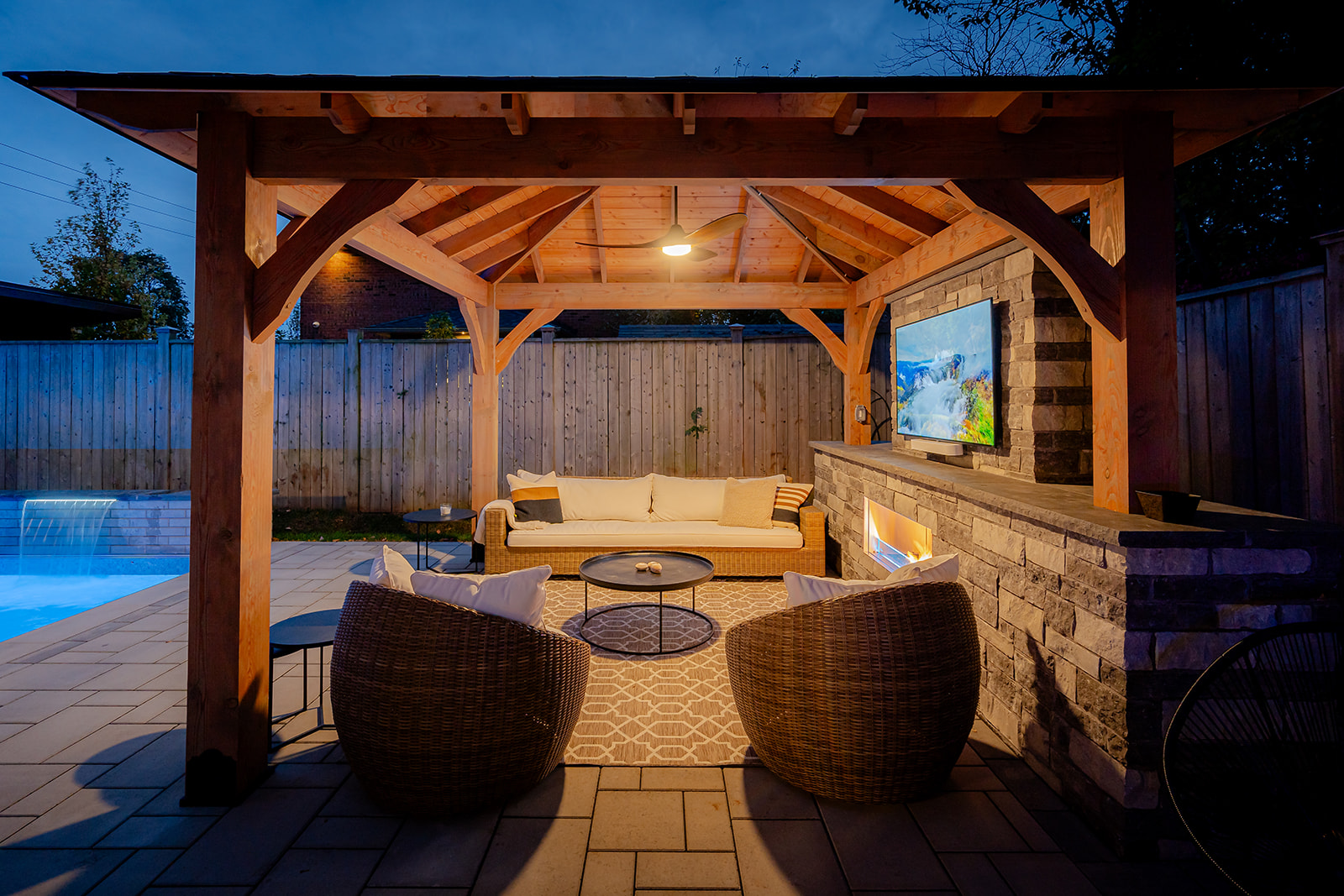 An outdoor patio set with a pool on the left.