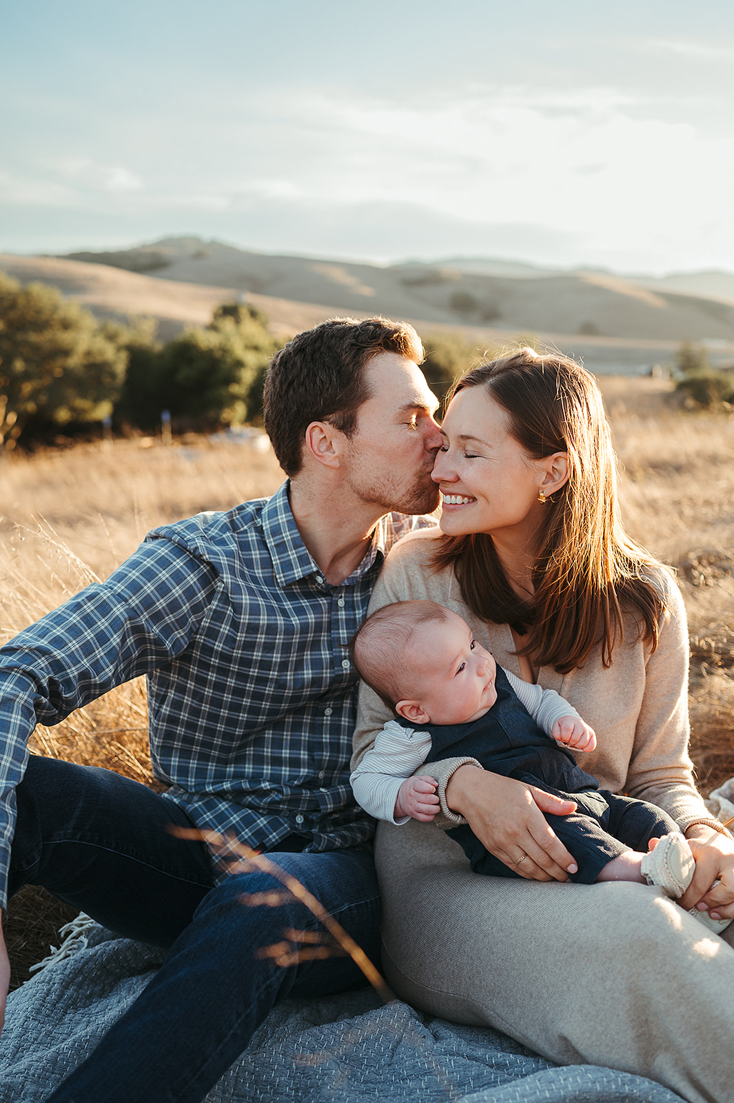 New parents holding baby during outdoor photo session at Helen Putnam in Petaluma by Sunshine Lady Photography