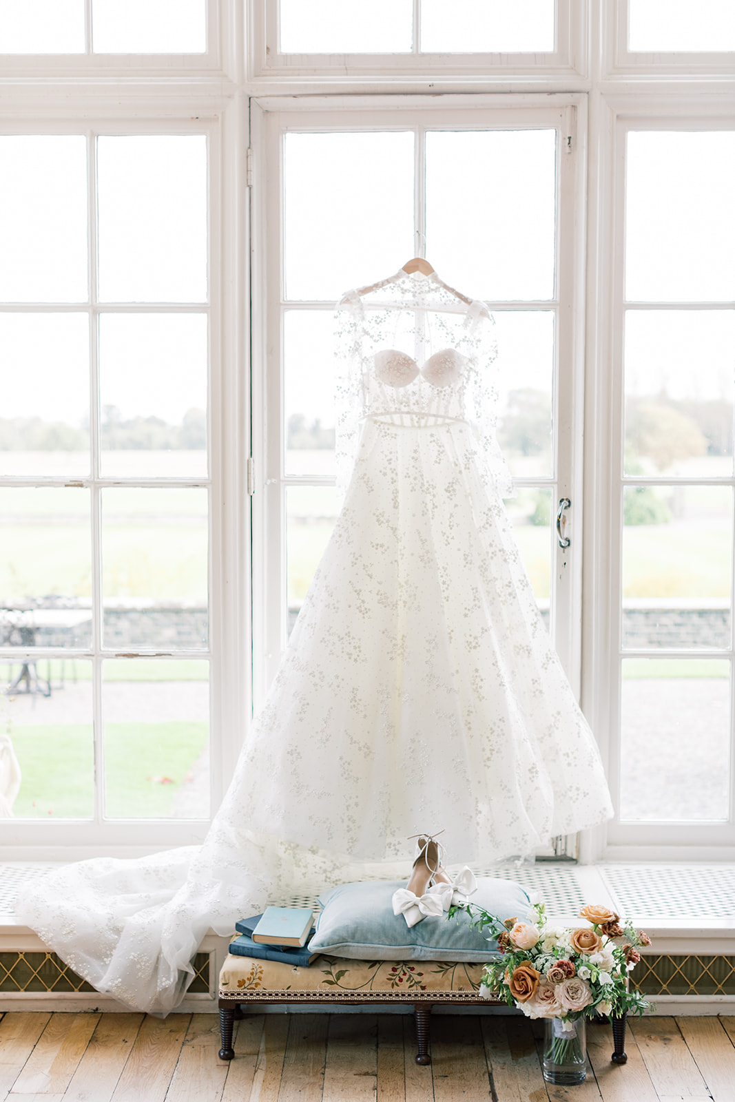 dress hanging in the window at luttrellstown castle wedding