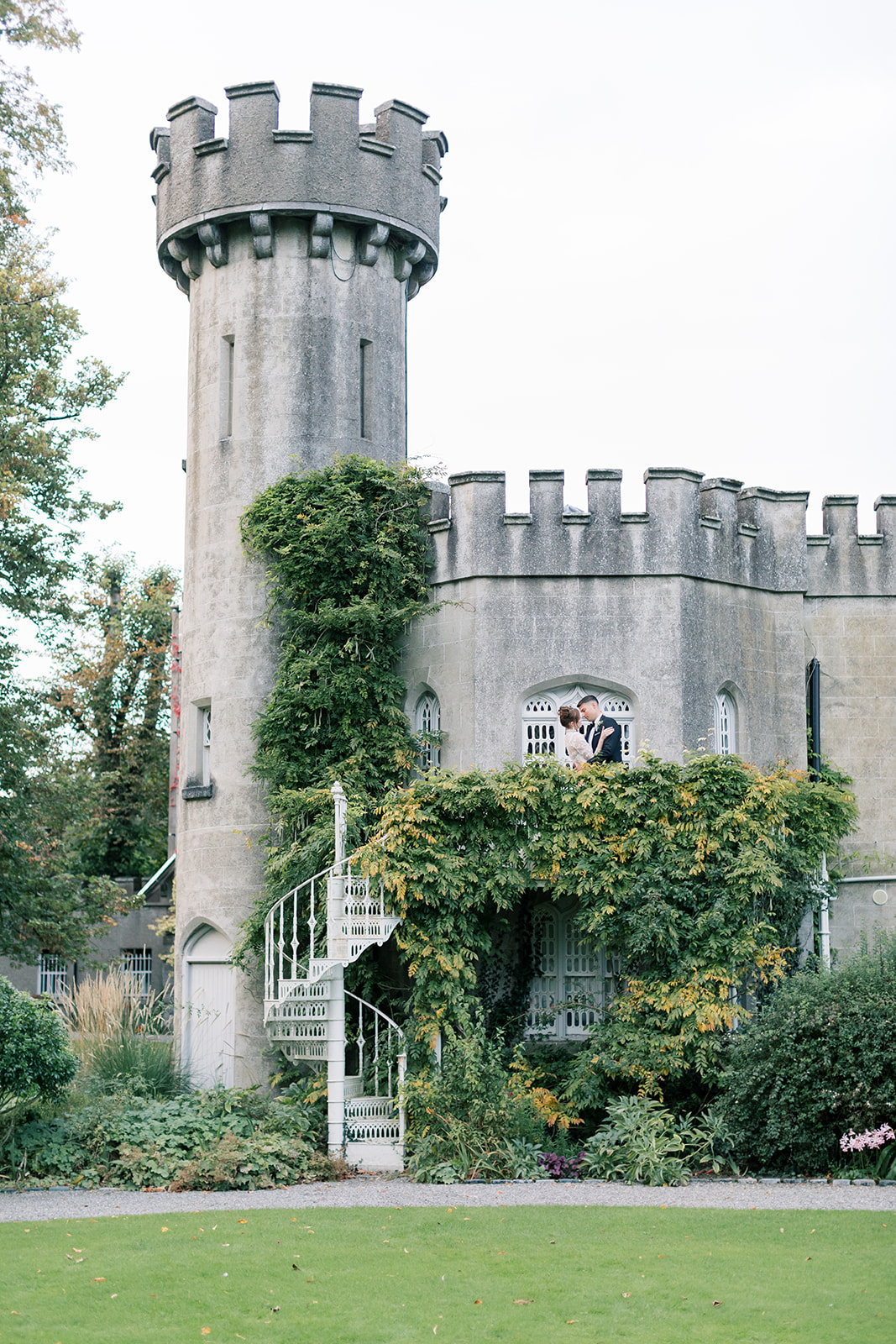 couple's wedding portraits climbing the tower of luttrellstown castle in dublin ireland